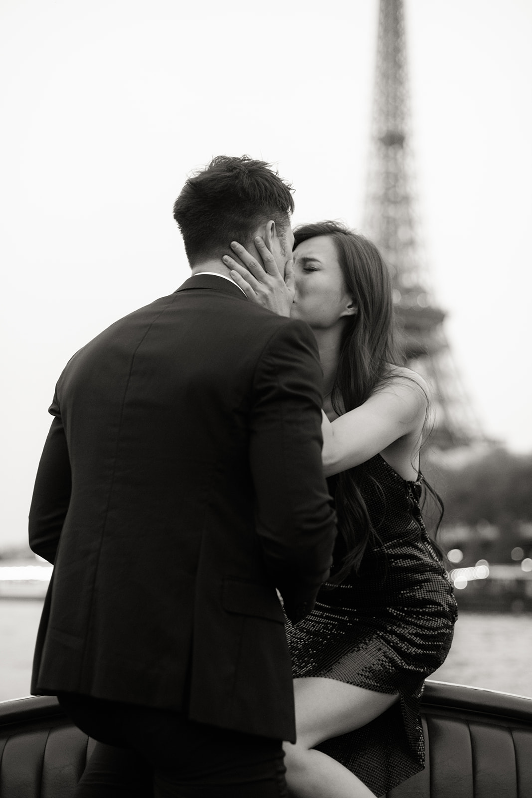 Couple decorating pastries together during a romantic engagement session in Paris